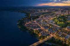 A growing city extending from a historic centre toward new neighbourhoods and transport corridors