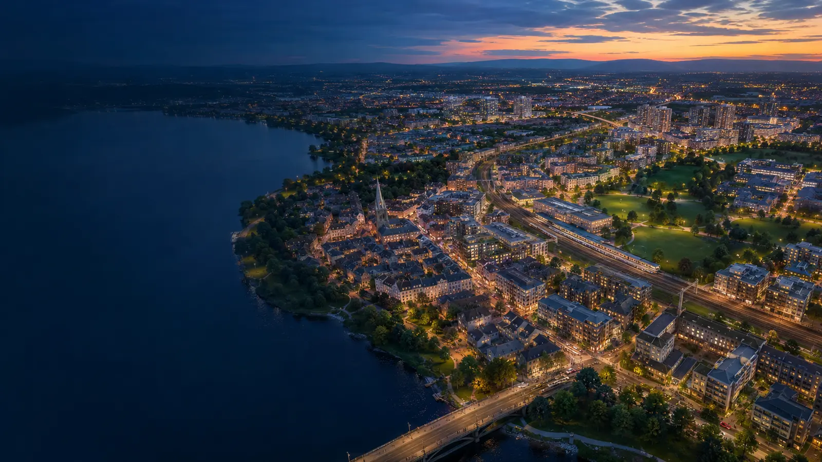 A growing city extending from a historic centre toward new neighbourhoods and transport corridors