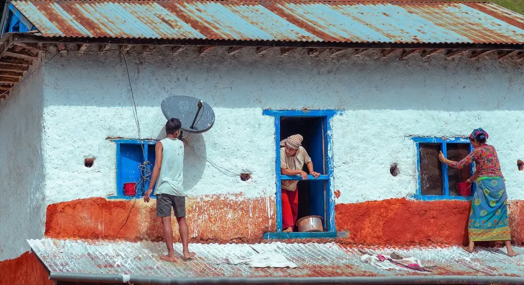 A family preparing and repainting a home for Dashain in Nepal