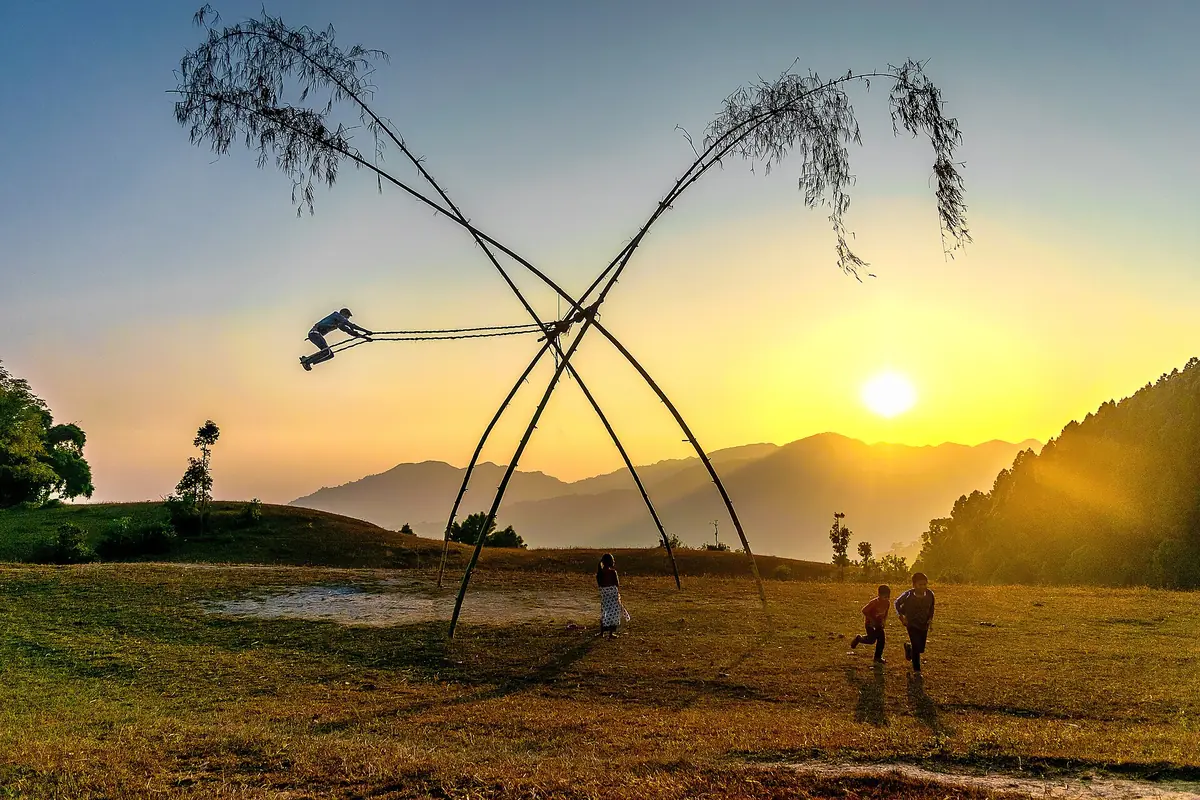 Children playing on a traditional linge ping during Dashain in Palpa Nepal