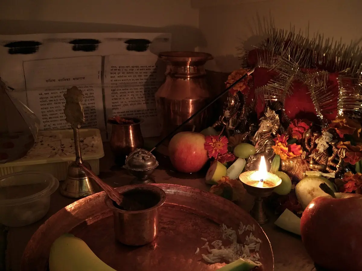 Dashain worship space with offerings sacred vessel lamp and jamara