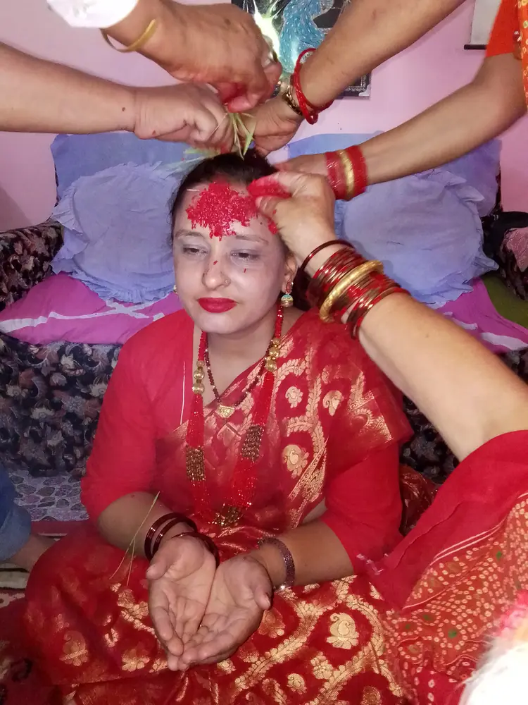 Family members applying tika during the Dashain visiting period in Nepal