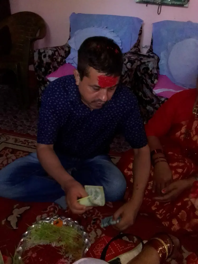 A man with Dashain tika during an extended family visit in Nepal