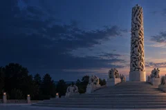 Editorial illustration of the Monolith in Vigeland Park rising above granite terraces