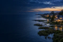 Coastal city and wetlands meeting a visibly elevated blue sea