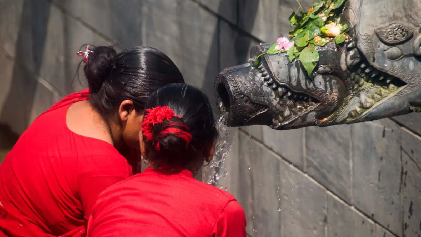 Women performing a Teej water ritual at Pashupatinath in Kathmandu
